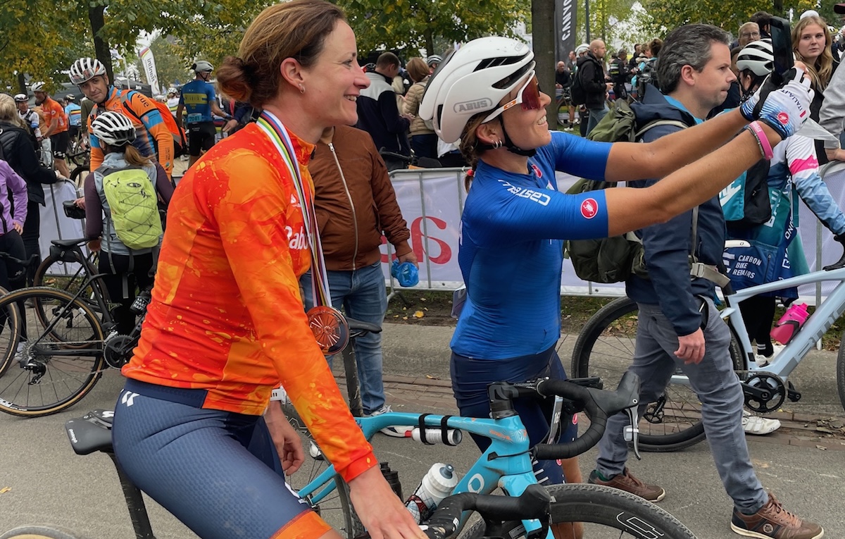2025 silver medalist Marianne Vos (Netherlands) at UCI Gravel World Championships poses for a selfie with an age-division rider in Maastricht