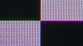 A close-up of the QD-OLED subpixel structure when displaying a black-and-white checkerboard pattern. The image illustrates how rows of pixels appear to be green- and magenta-colored whenever light objects meet dark objects.