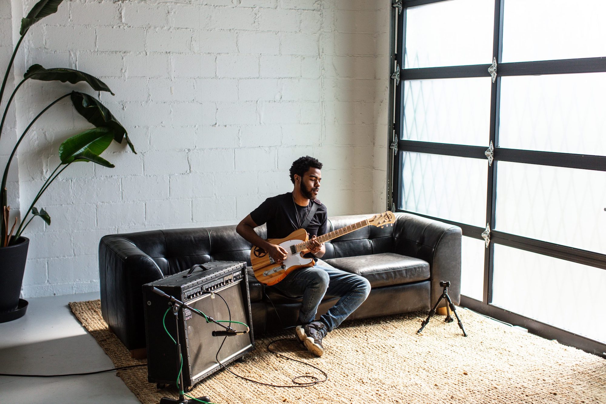 A man plays Jeep's Wallace Detroit-built guitar