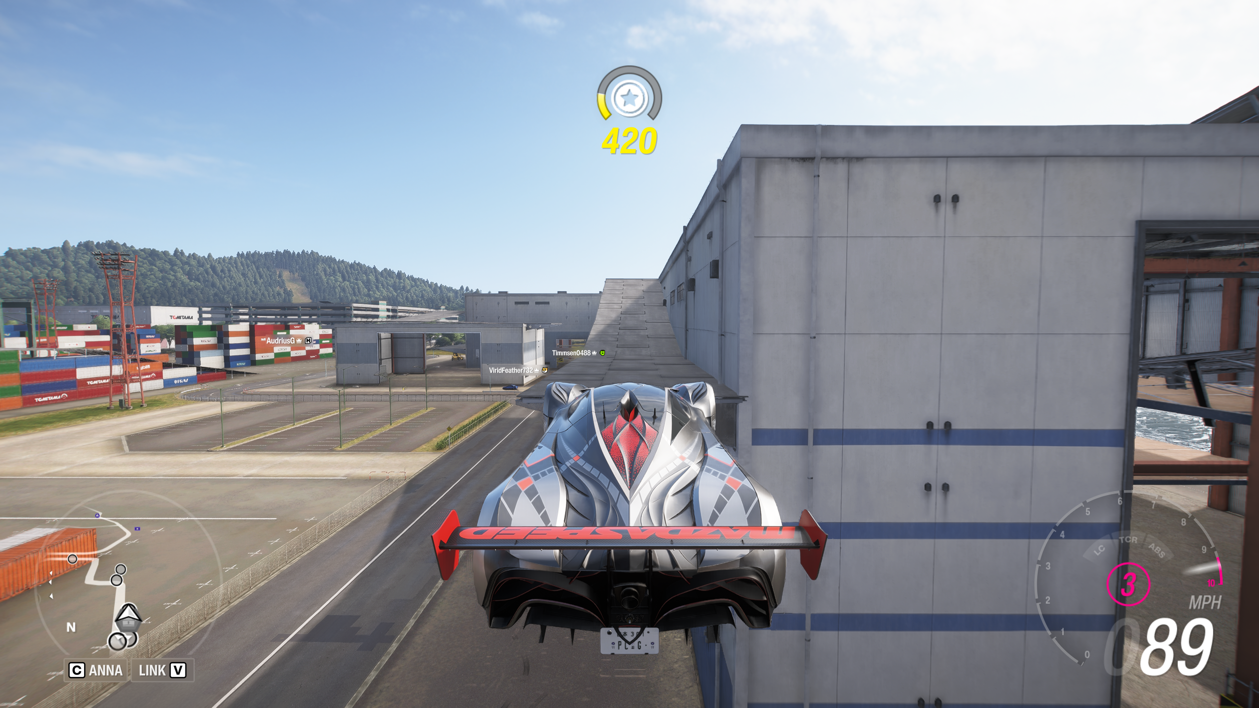 Forza Horizon 6 Tokyo City Treasure Hunt location: A Mazda Furai driving up a ramp on the side of a warehouse.