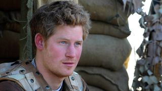 Prince Harry looks thoughtful as he sits at the observation post on JTAC Hill