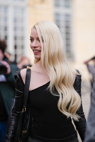 Anya Taylor-Joy wearing a dior D Journey bag to a Dior show at Paris Fashion Week