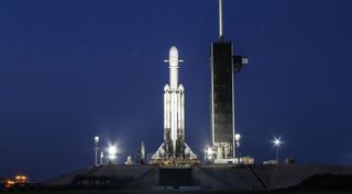 A SpaceX Falcon Heavy launch vehicle stands on Launch Complex-39A at NASA's Kennedy Space Center in the early morning hours of June 24, 2019.