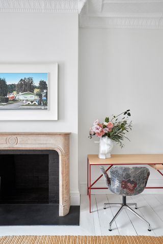 fireplace with desk and chair