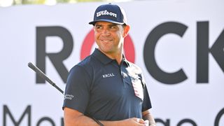 Gary Woodland smiles while stepping onto the 10th tee box during the first round of the Rocket Mortgage Classic at Detroit Golf Club 