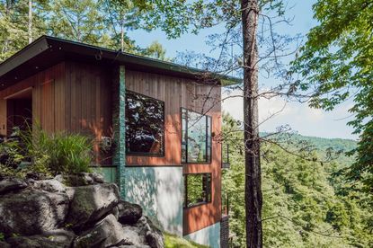 timber and stone form this Japanese chalet in the woods by AB Concepts