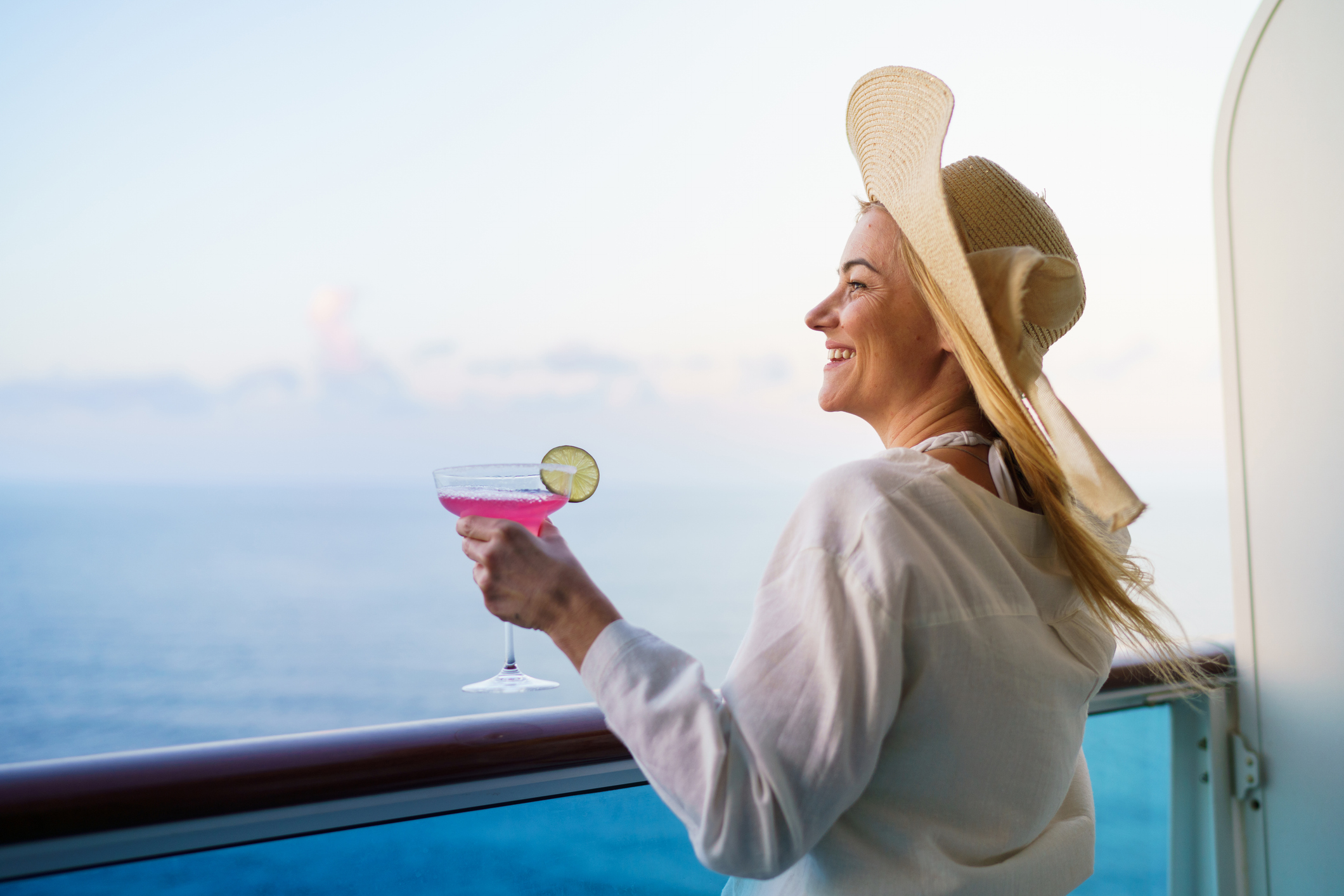 Woman enjoying a drink on a cruise ship.