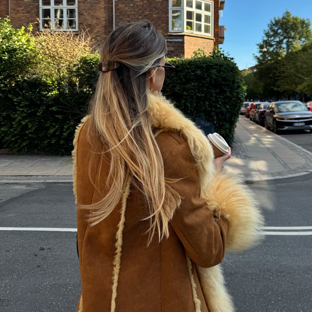 Anna Winck with brown hair and blonde highlights