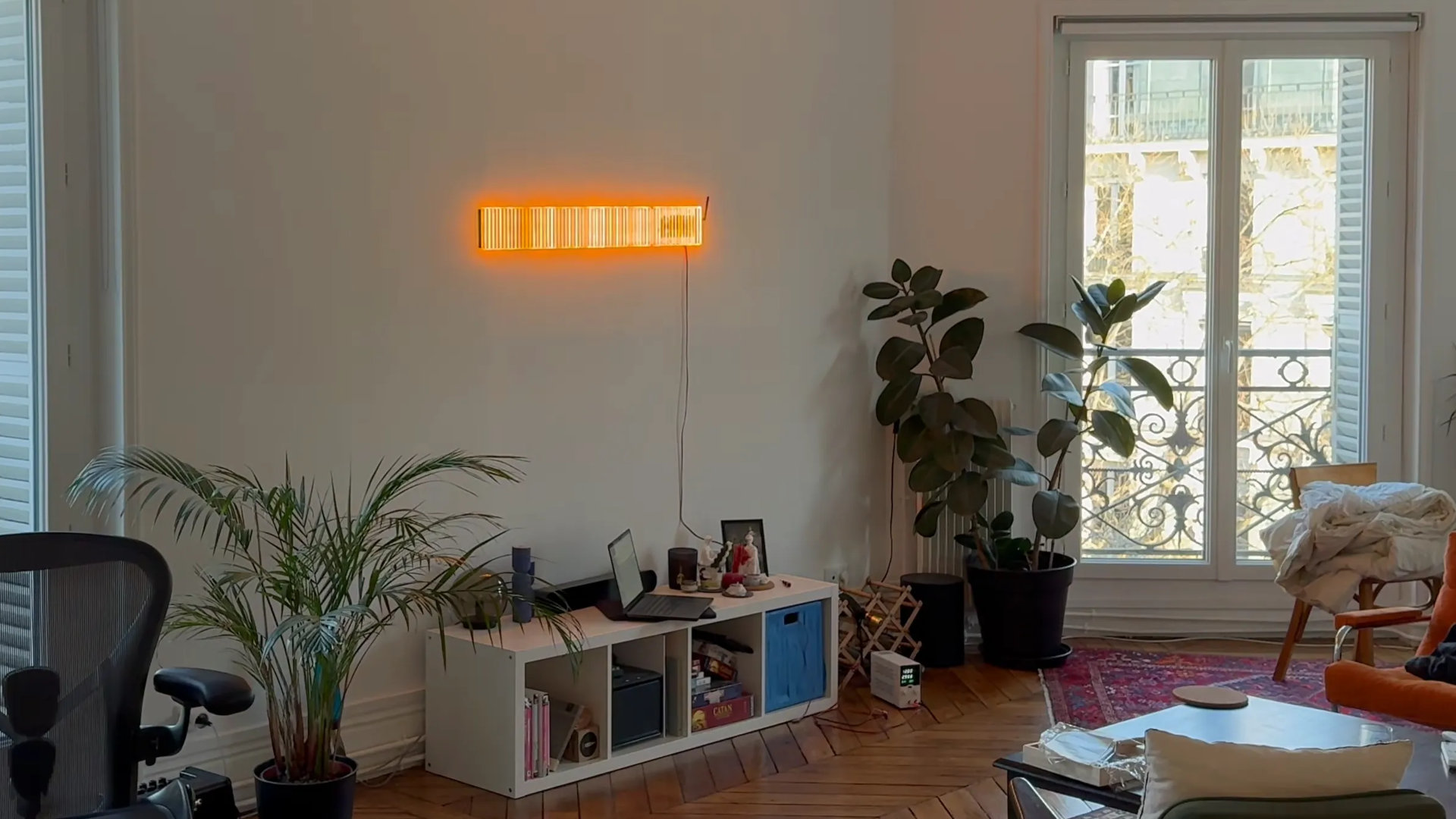 A photograph of an apartment, showing an engineering art sculpture called Spectrum Slit, as created by Rootkid