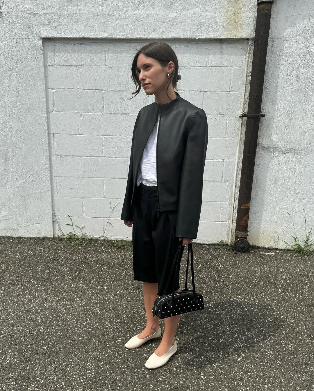 Laura Reilly carrying a studded Alaia Teckel bag