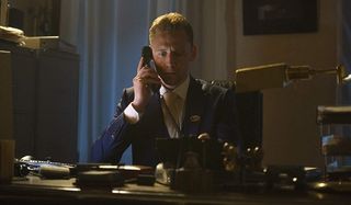 The Night Manager Tom Hiddleston at his desk, on the phone