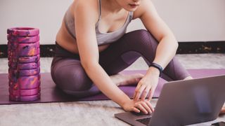 Woman buying new fitness clothes and equipment online