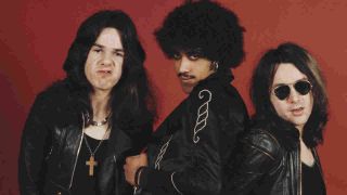 Gary Moore posing for a photograph with Thin Lizzy in 1974