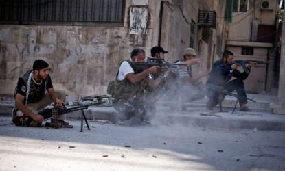 Free Syrian Army soldiers shoot their weapons toward Syrian Army opposition in Aleppo on Sept. 8.
