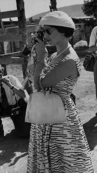 Princess Margaret wearing a zebra print dress and taking photos