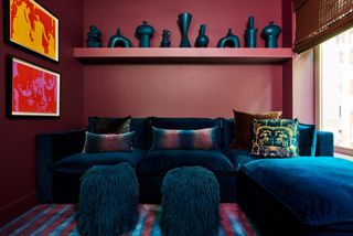 Rich dark tones can be found in the apartment’s library, where a blue velvet Joybird sofa is topped with cushions by Kevin O’Brien Studio and Gucci Décor