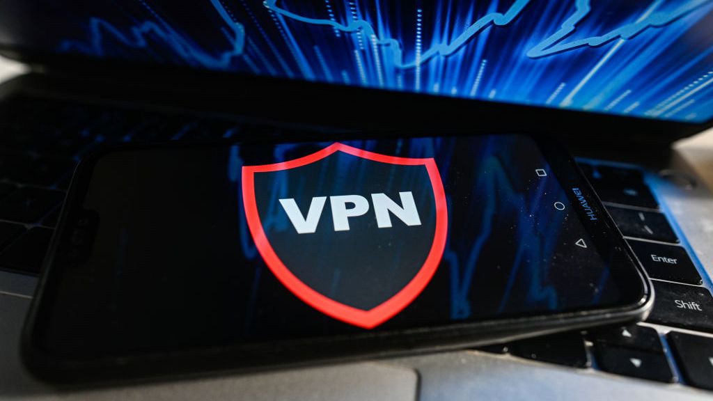 A VPN runs on a mobile phone placed on a laptop keyboard