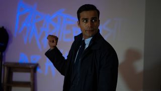 DS Khalil Amin examines a crime scene with the word PARASITE written on the wall