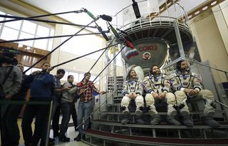 Russian cosmonaut Alexey Ovchinin flanked by NASA astronauts Christina Koch and Nick Hague at the Gagarin Cosmonaut Training Center in Star City, Russia, as they prepare for their launch aboard the Soyuz MS-12 in March 2019.