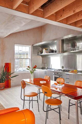 open plan kitchen with digital colors used on the orange table and chairs