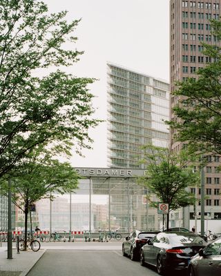 walking through Potsdamer Platz in Berlin and its postmodernist architecture, showing large scale buildings with transparencies and grids