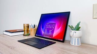 Asus Zenbook 17 Fold OLED review unit on desk with Windows 11 home screen showing