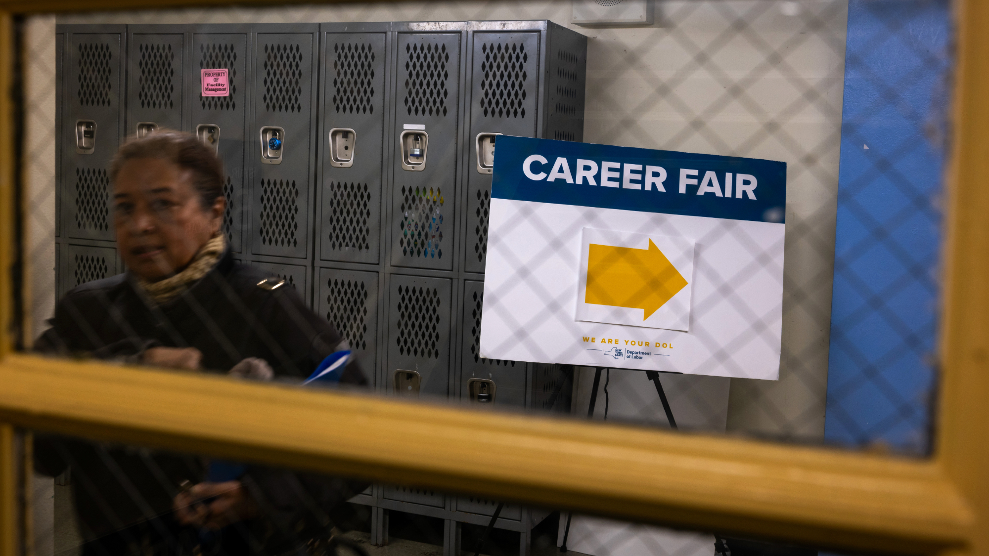 Woman at career fair as unemployment rises