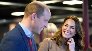 Prince William and Kate Middleton, now Prince and Princess of Wales, smile during a visit to the Church on the Street in Burnley in 2022