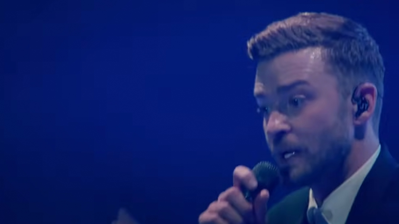 Close up of Justin Timberlake singing into a microphone