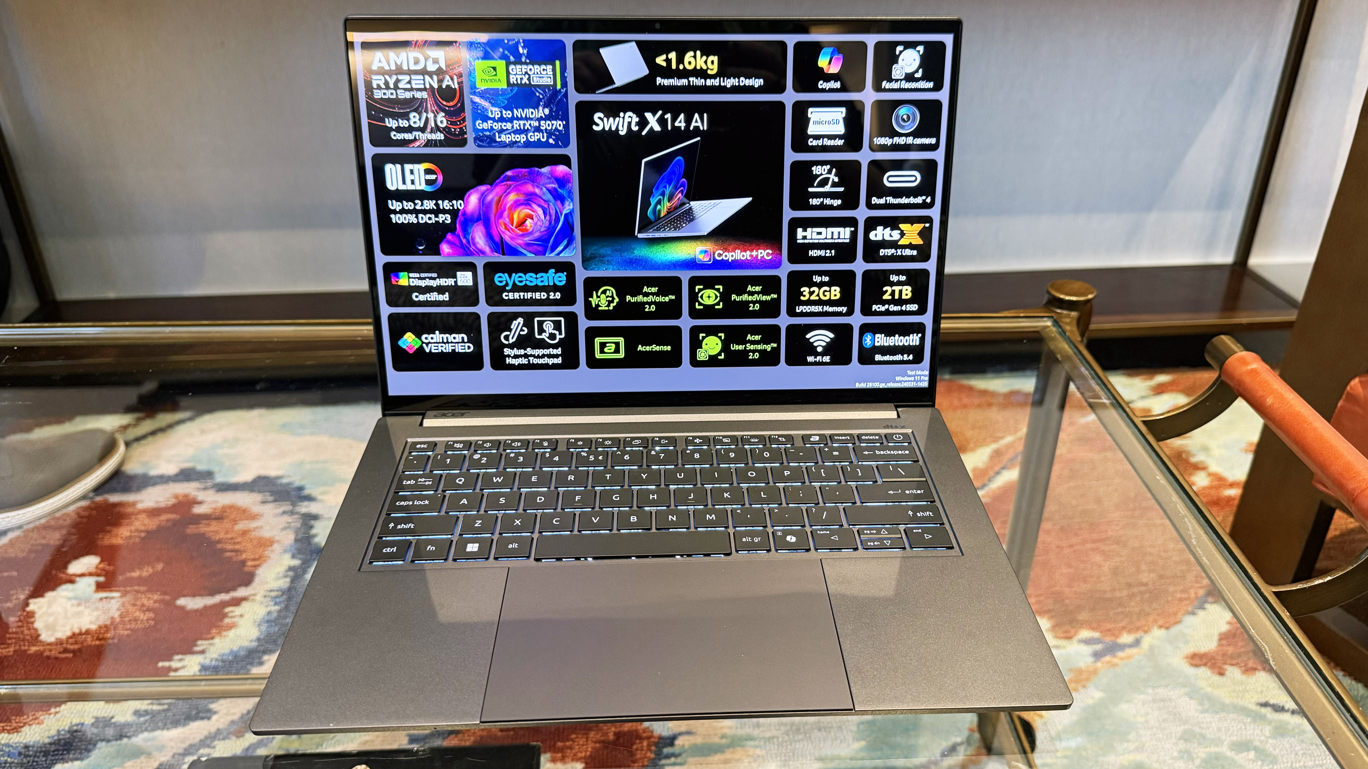 Acer Swift X 14 AI creator laptop open facing on a glass table.