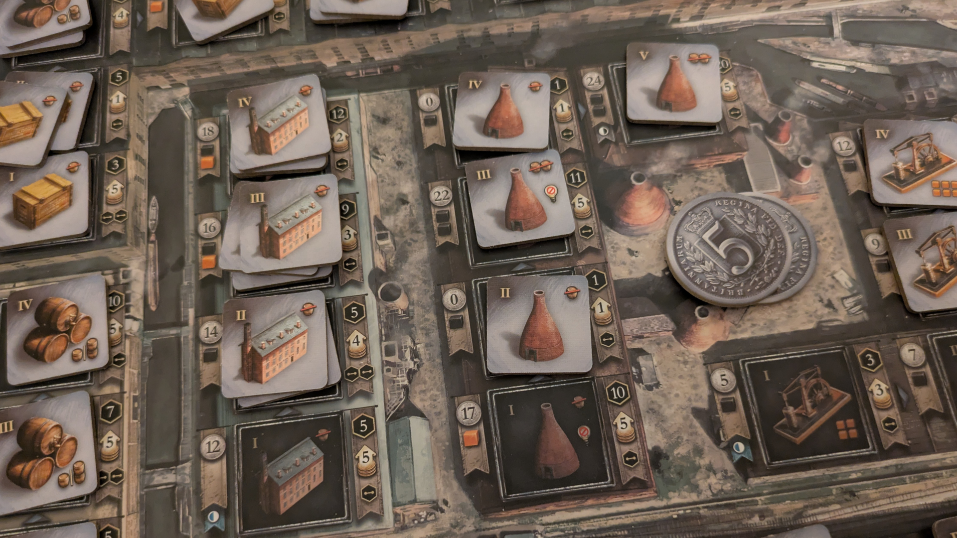 Brass: Birmingham factory and kiln tokens on the board, with coins visible