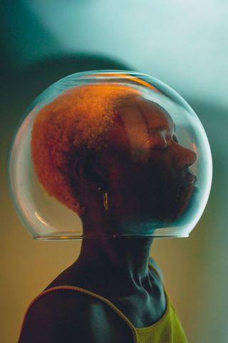 A woman with a fish bowl on her head