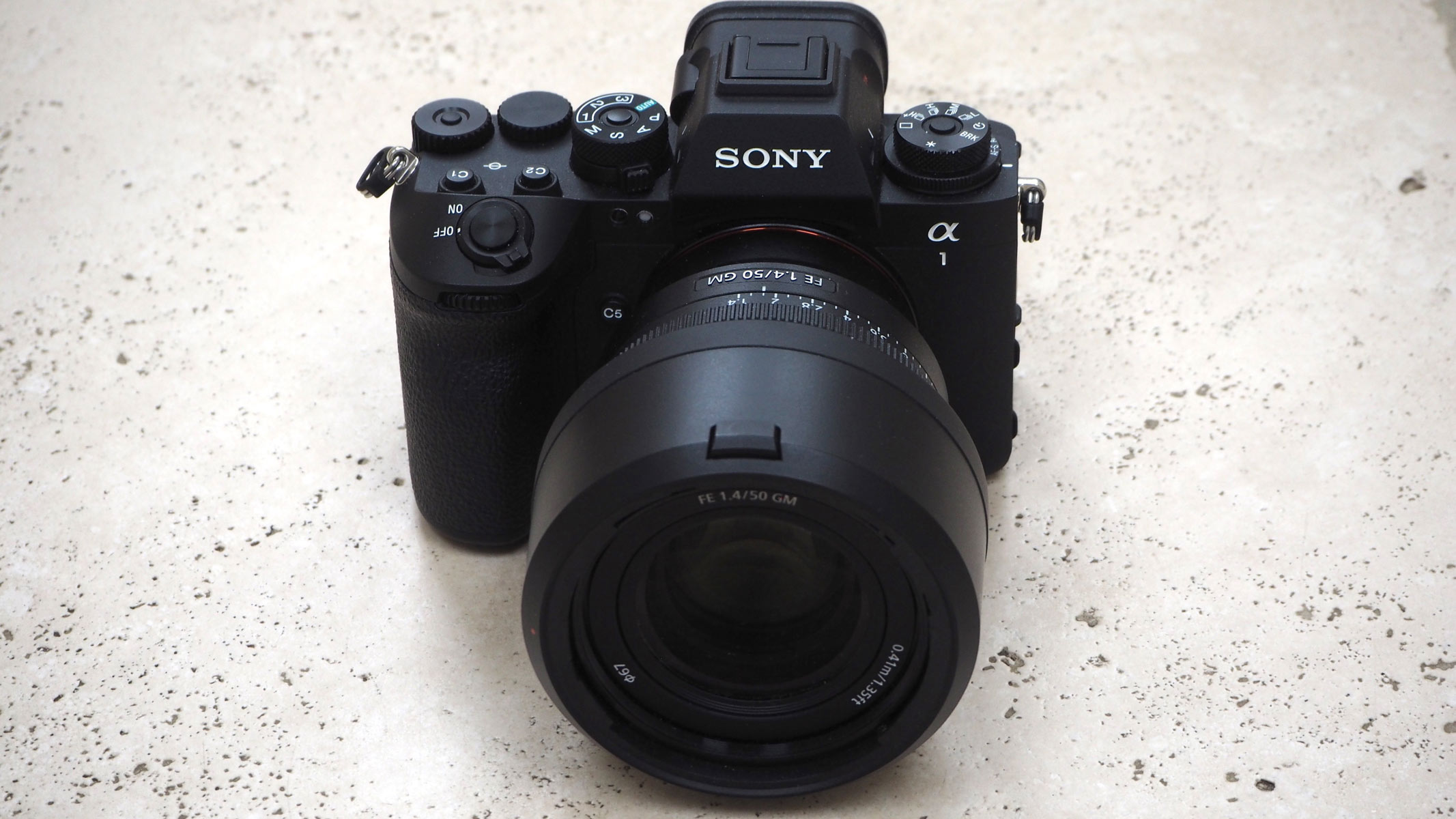 The Sony A1 II camera with lens attached on a white table.