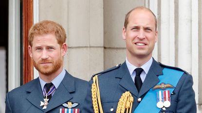 Prince Harry, Duke of Sussex and Prince William, Duke of Cambridge watch a flypast to mark the centenary of the Royal Air Force from the balcony of Buckingham Palace on July 10, 2018