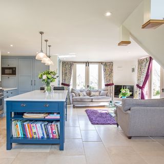 open white kitchen with sofa and blue furniture