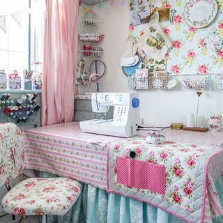 craft room with floral cover on table floral chair and white machine