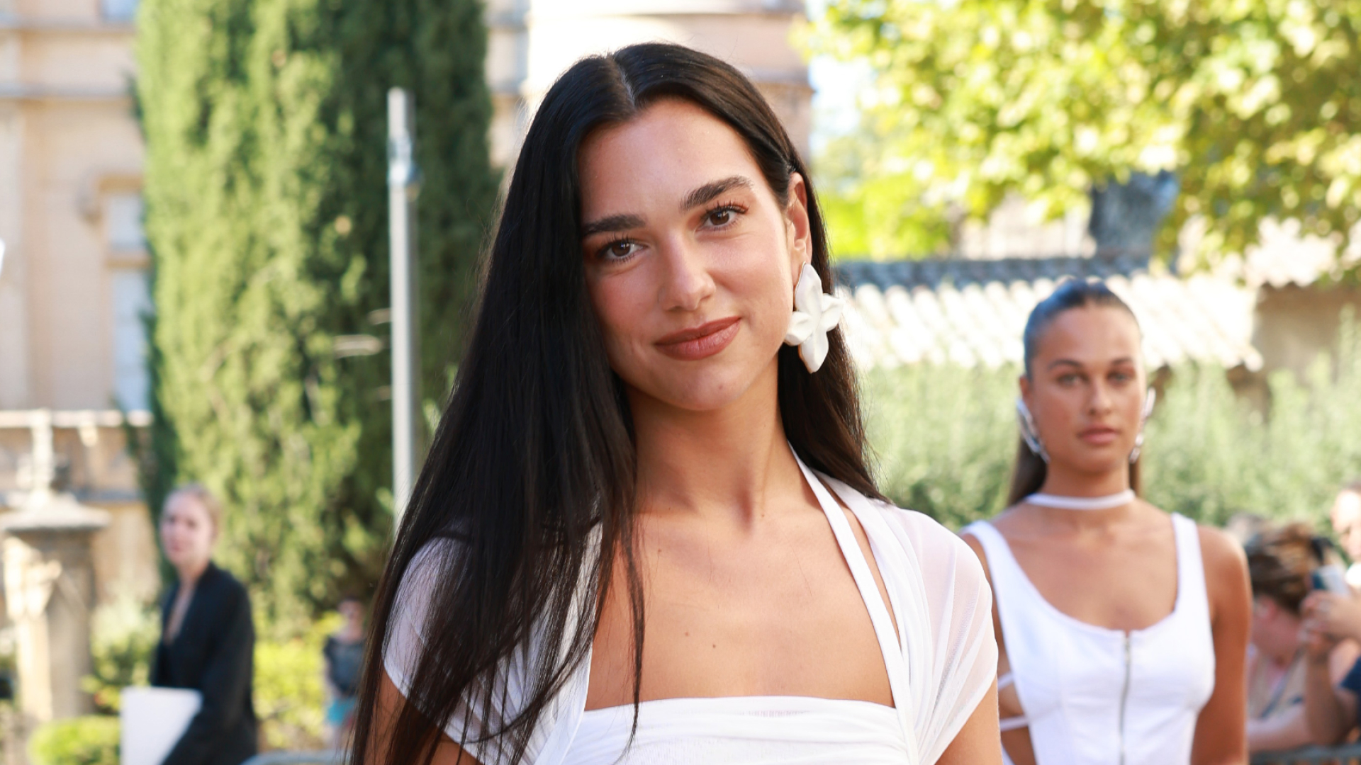 Dua Lipa wearing a white dress