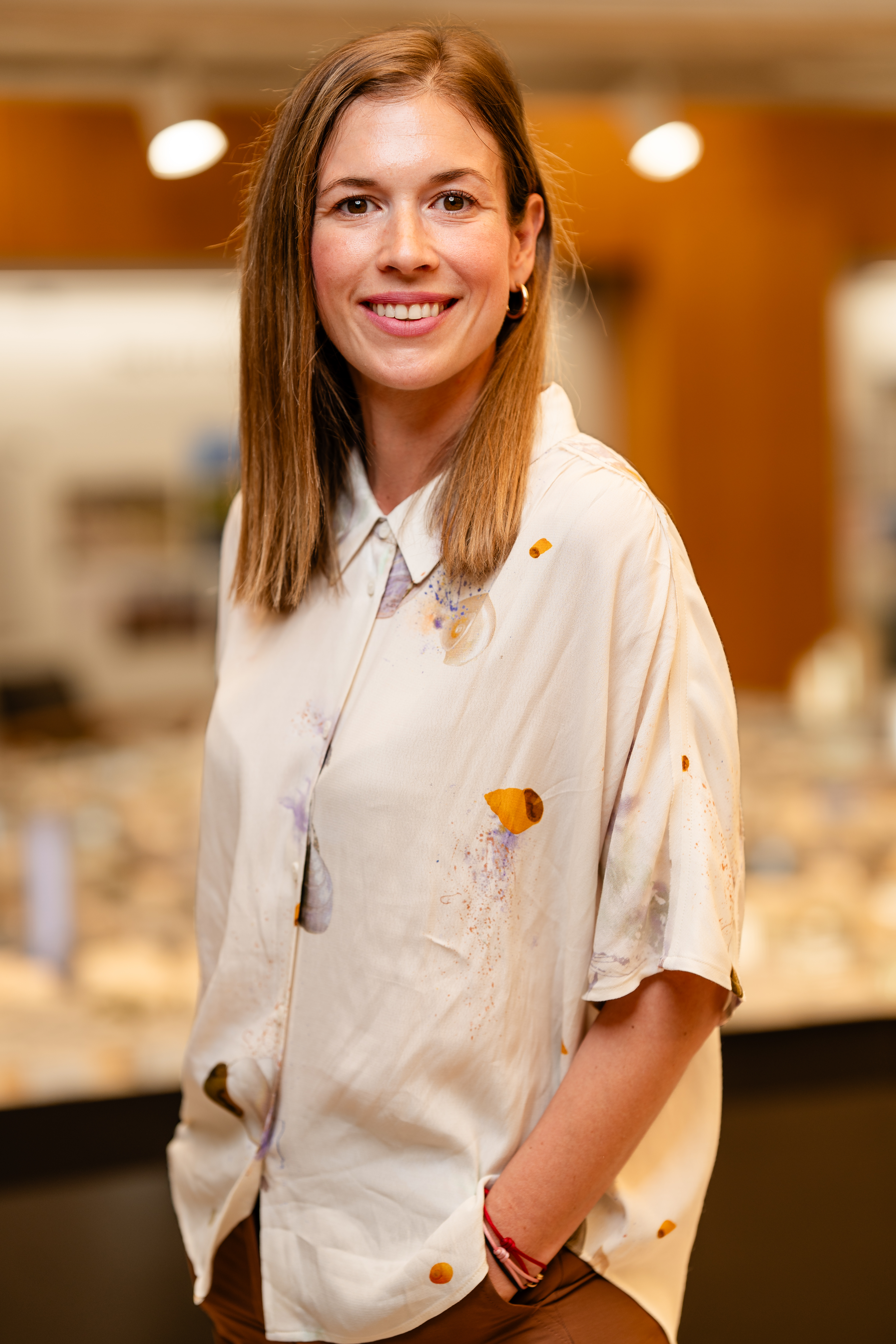 portrait of Rosa Rogina in colour, she's wearing white shirt with small patterns in orange