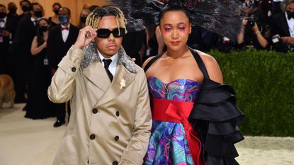 Japanese tennis player Naomi Osaka (R) and US singer Cordae arrive for the 2021 Met Gala at the Metropolitan Museum of Art on September 13, 2021 in New York. - This year's Met Gala has a distinctively youthful imprint, hosted by singer Billie Eilish, actor Timothee Chalamet, poet Amanda Gorman and tennis star Naomi Osaka, none of them older than 25. The 2021 theme is "In America: A Lexicon of Fashion." 