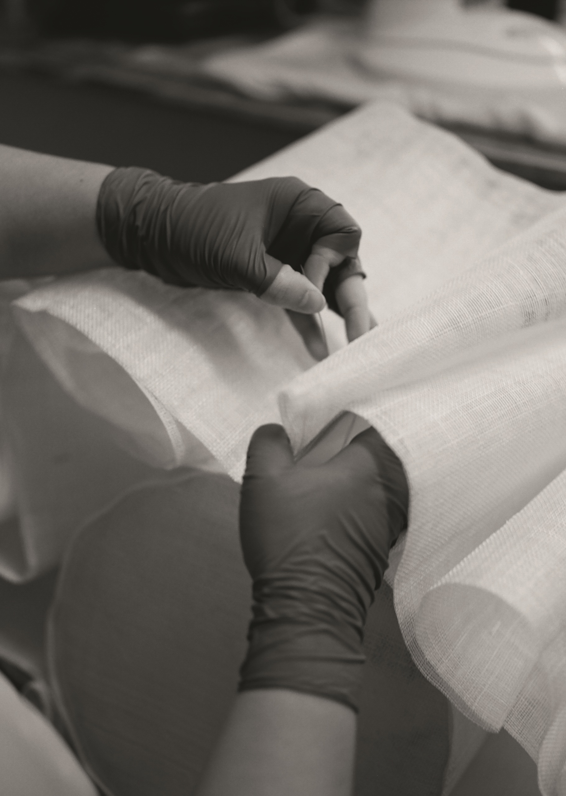 black-and-white photo of hands pleating a Anders light from Pinch