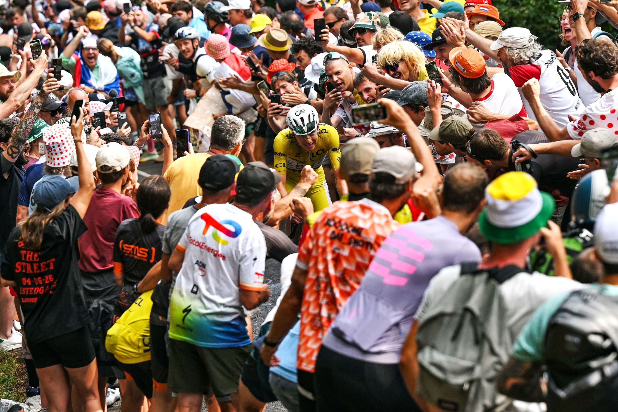 Tadej Pogacar rides through the crowds at the Tour de France