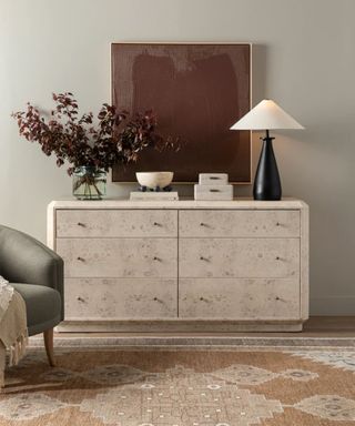 pale burl sideboard with fall decor and a rust colored vintage rug