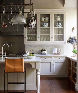 Neutral classic kitchen with a pot hanger over an island