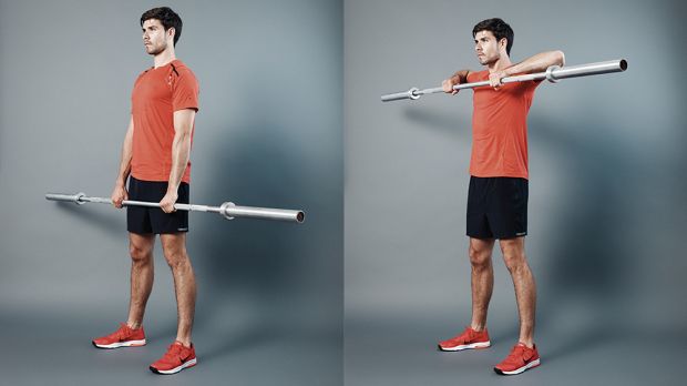 Man performs upright row shoulder exercise with empty Olympic barbell