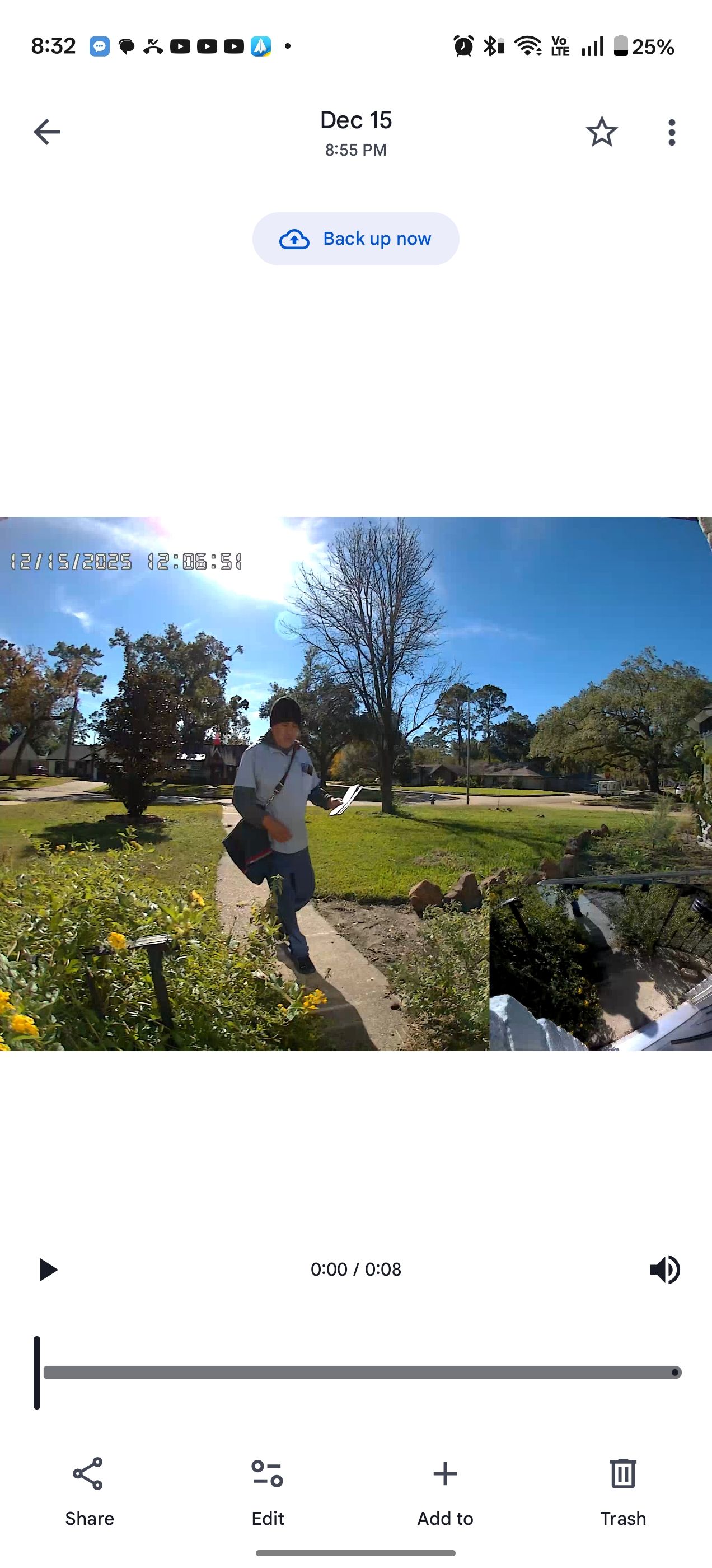 Screenshot of the Philips app showing a still from the Philips 7000 Series 2K Video Doorbell, of person approaching with grass and blue sky in background.