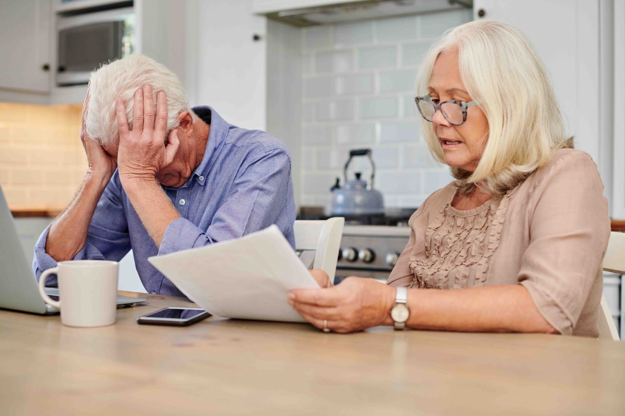 An older couple looking at paperwork.