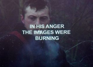 Photo of a man with "In his anger the images were burning" in front of him