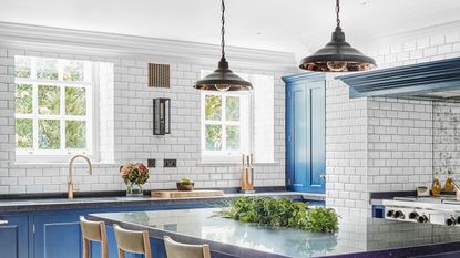 kitchen with white subway tile and blue abinets