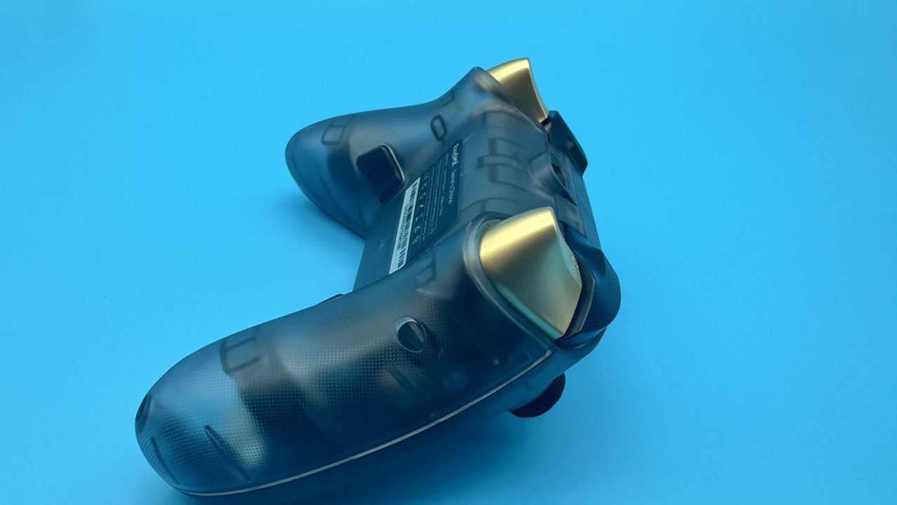 EasySMX D05 black gaming controller face down, from the right hand side, on a blue background