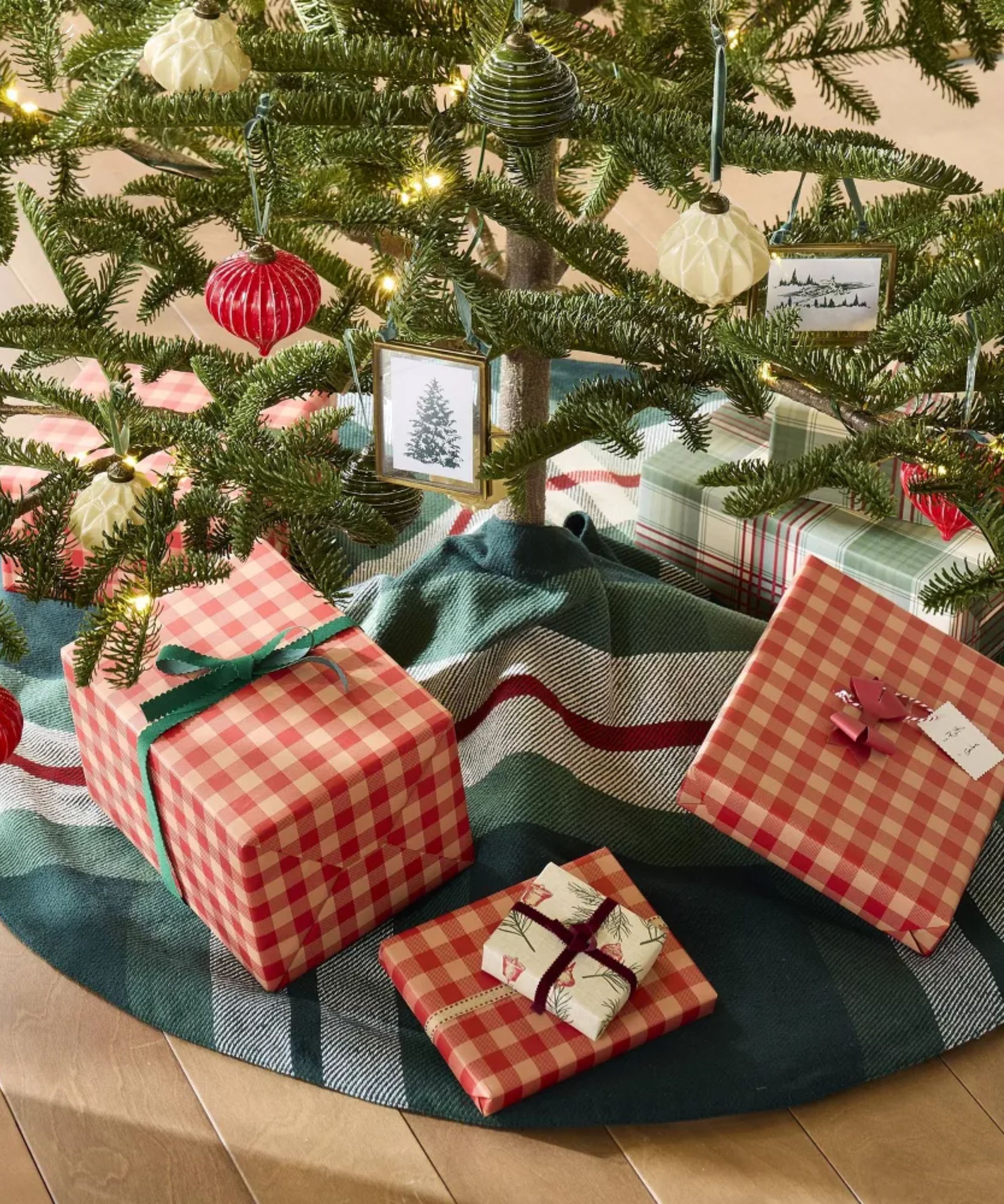 Christmas tree with plaid tree skirt and gifts wrapped in red gingham paper